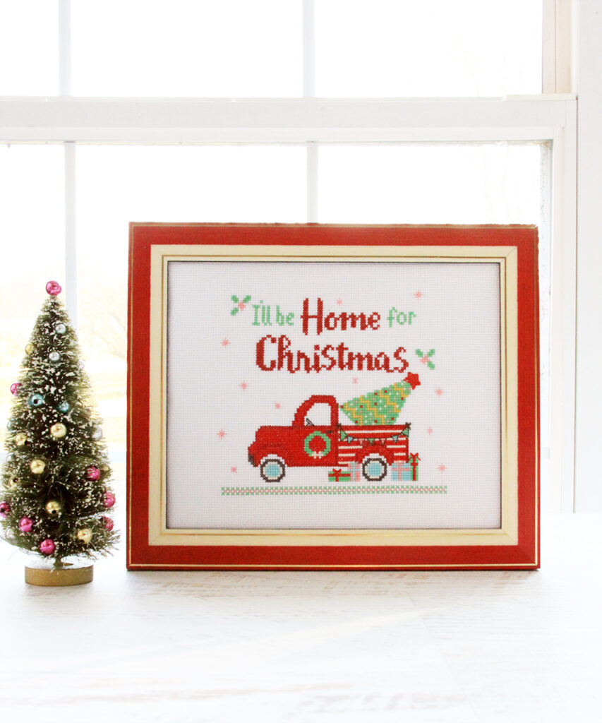 I'll Be Home for Christmas Cross Stitch Pattern by popular Tennessee quilting blog, Flamingo Toes: image of a framed Christmas cross stitch pattern.
